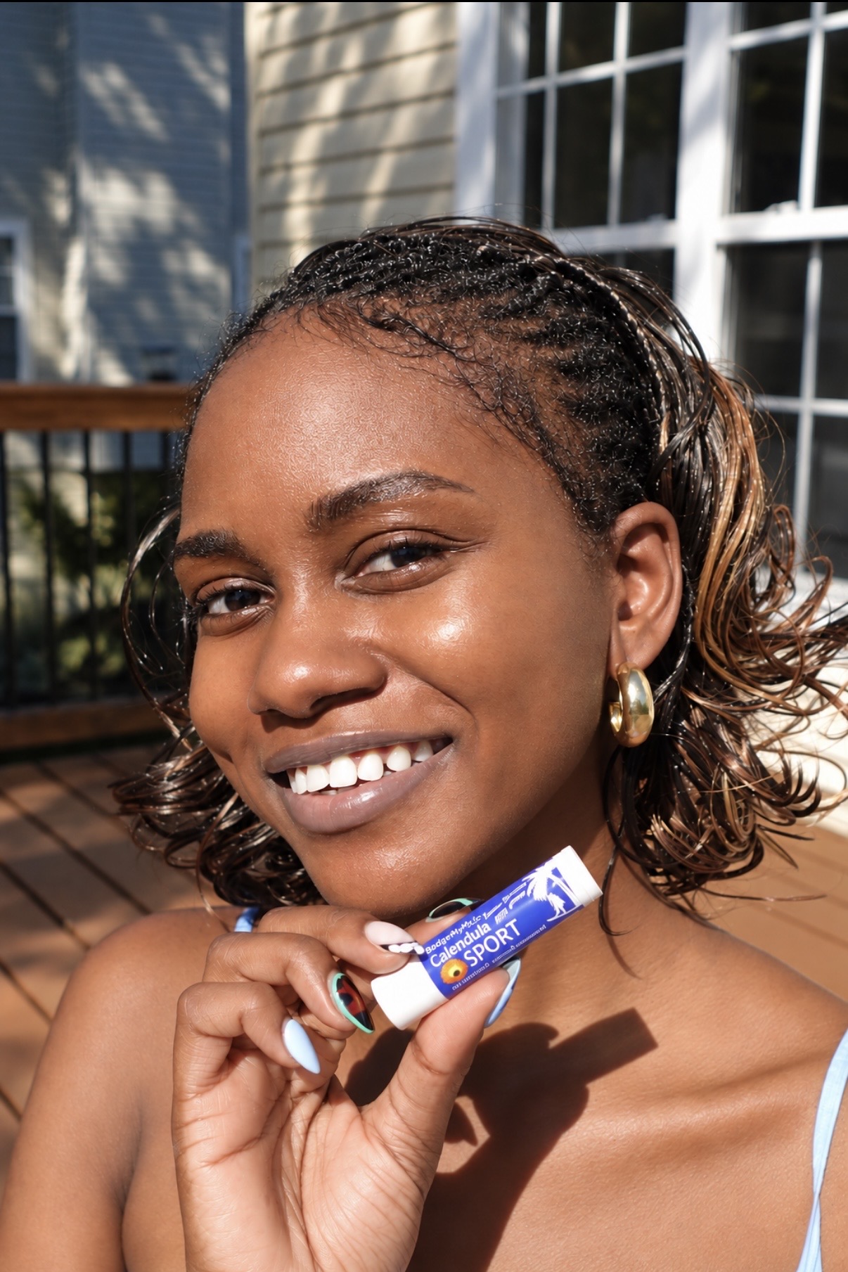 African American woman wearing sheer Calendula Sport to show the zinc oxide is sheer